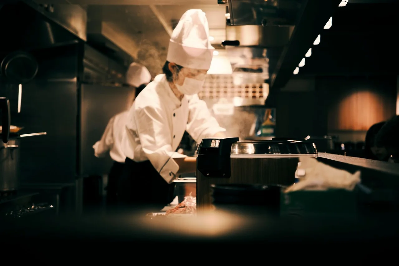 Kitchen chef checking mise en place in neat restaurant station