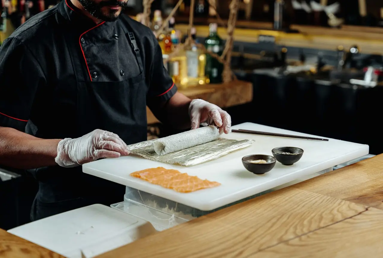 Chef preparing vegetable garnish and fresh maki ingredients